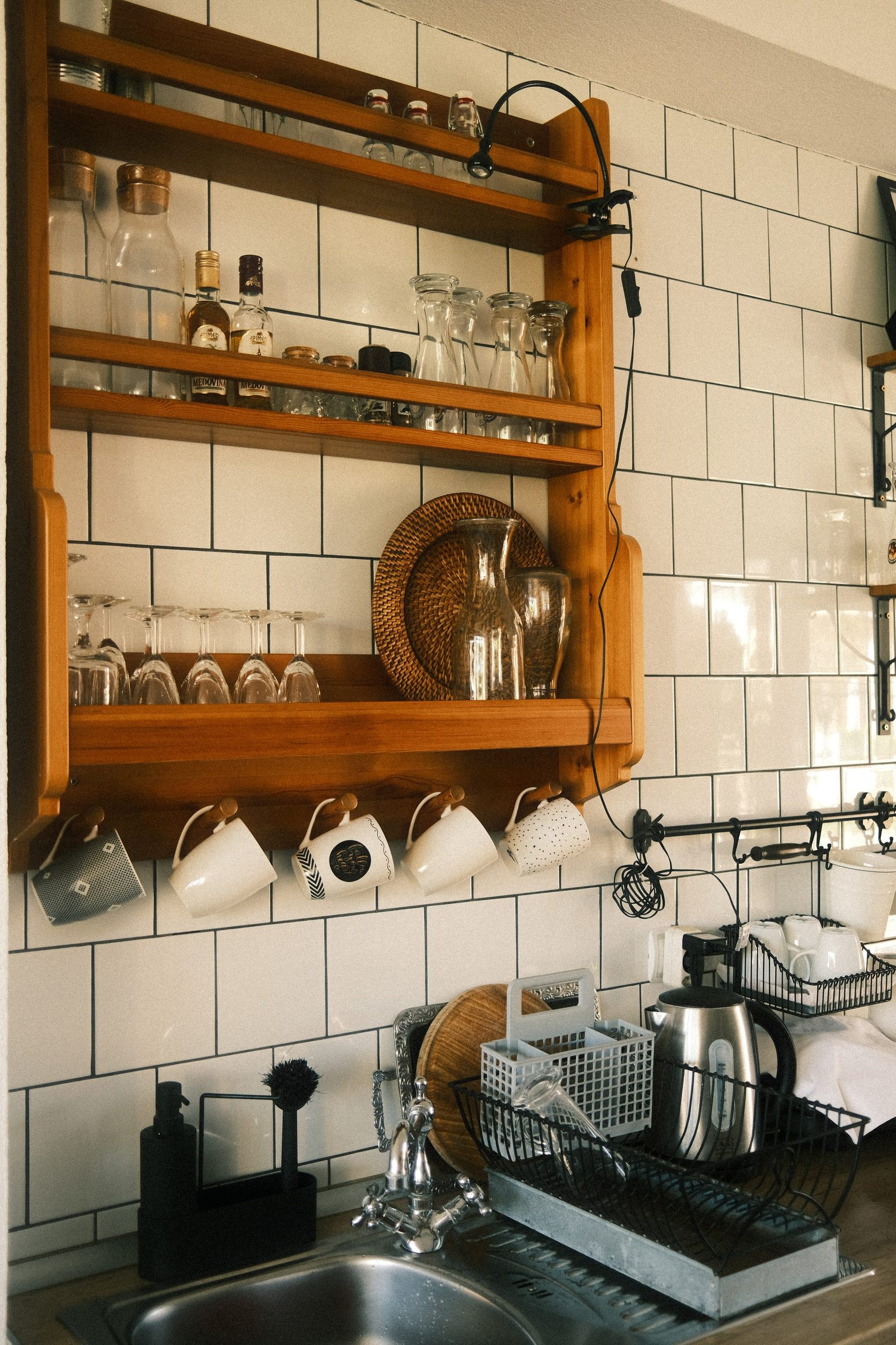 Glassware and mugs on open kitchen shelves